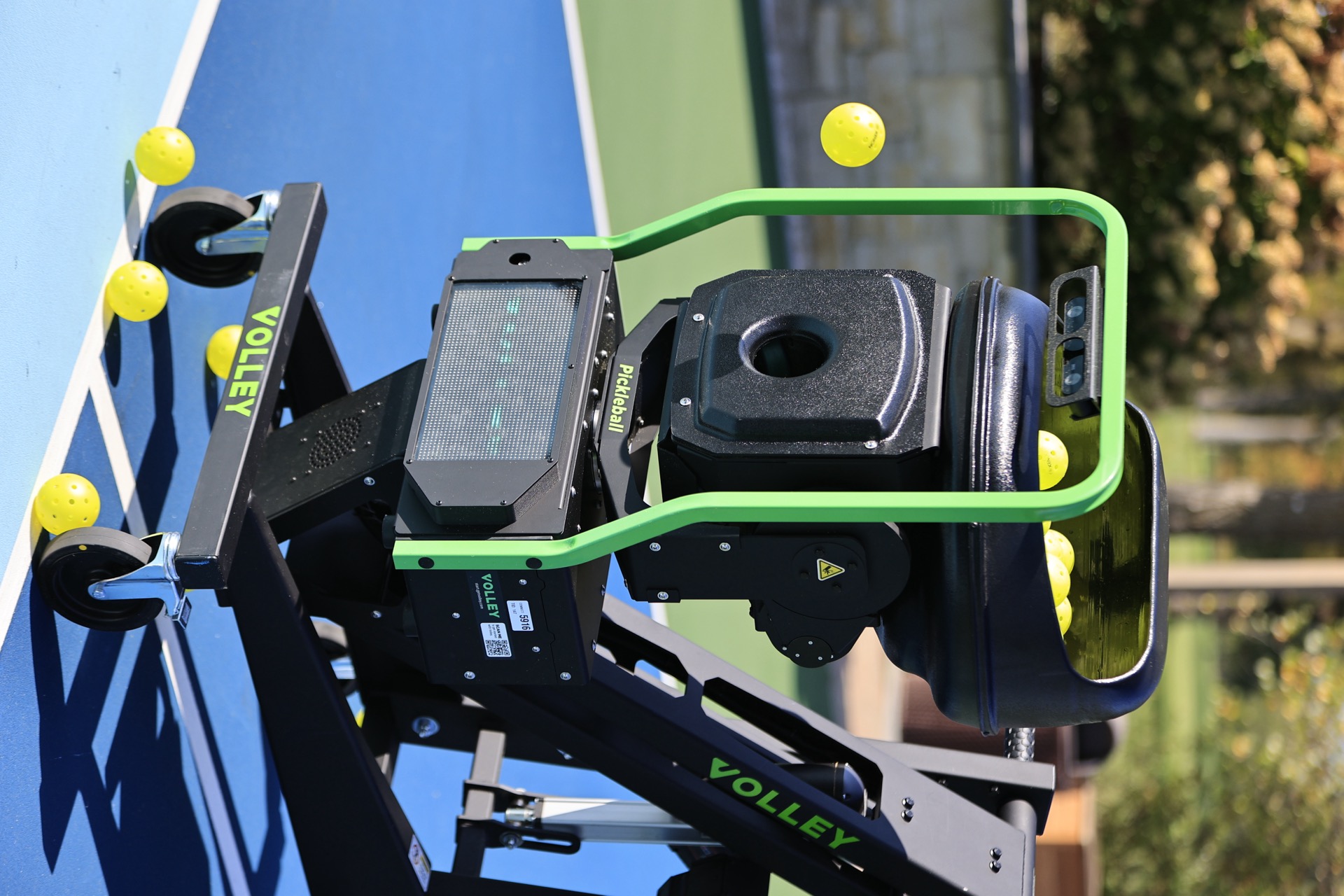 A Volley trainer loaded with pickleballs on an outdoor court — DUPR ratings from a Volley session