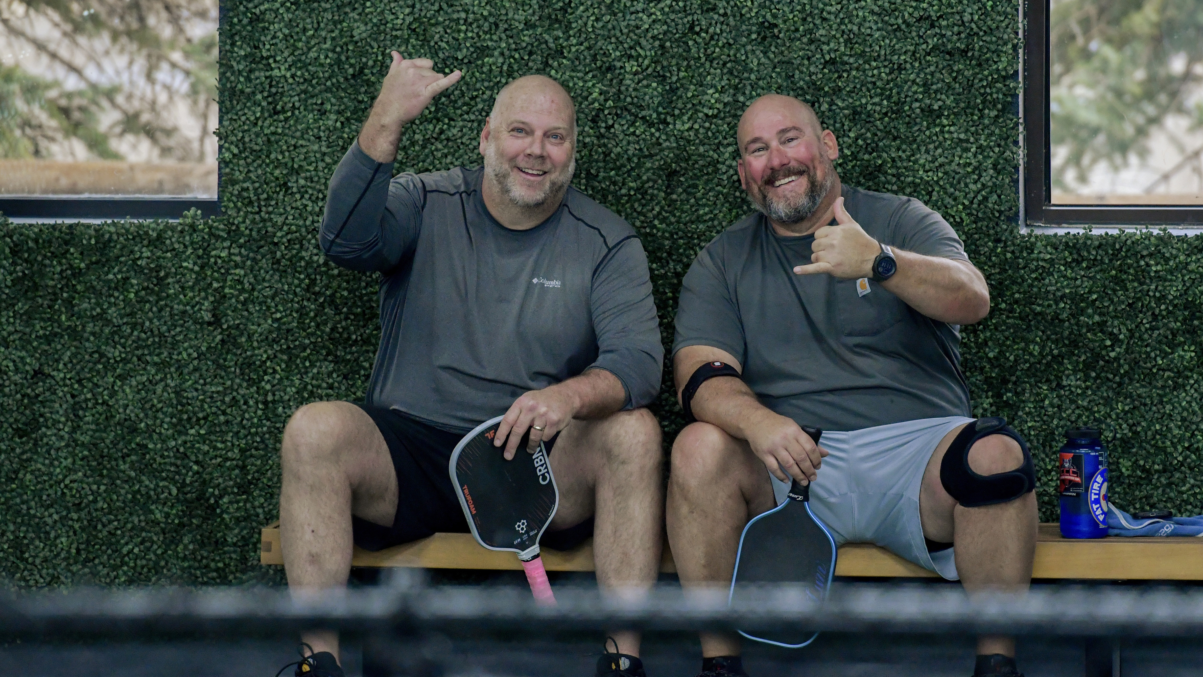 Two members relaxing courtside at Zero Zero Two